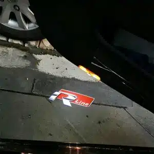 VW R Line door lights projecting the sharp, silver-and-black performance R logo onto the ground in bright LED.