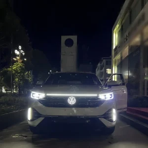 VW Tayron light up emblem glowing white LED badge at night on new Tayron SUV