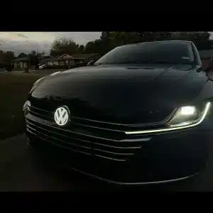VW Arteon second generation light up emblem lit at night showing white LED badge on 2021 front grille